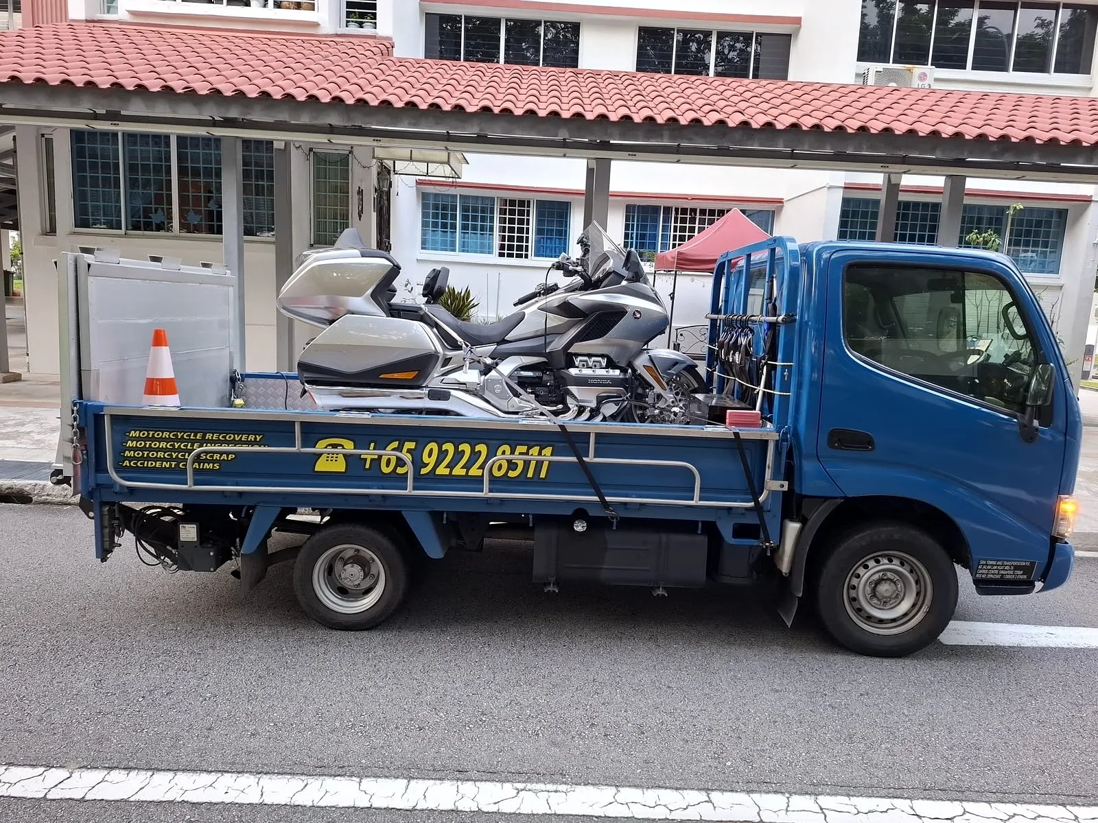 Branded Siva Towing lorry carrying a motorcycle on an islandwide job