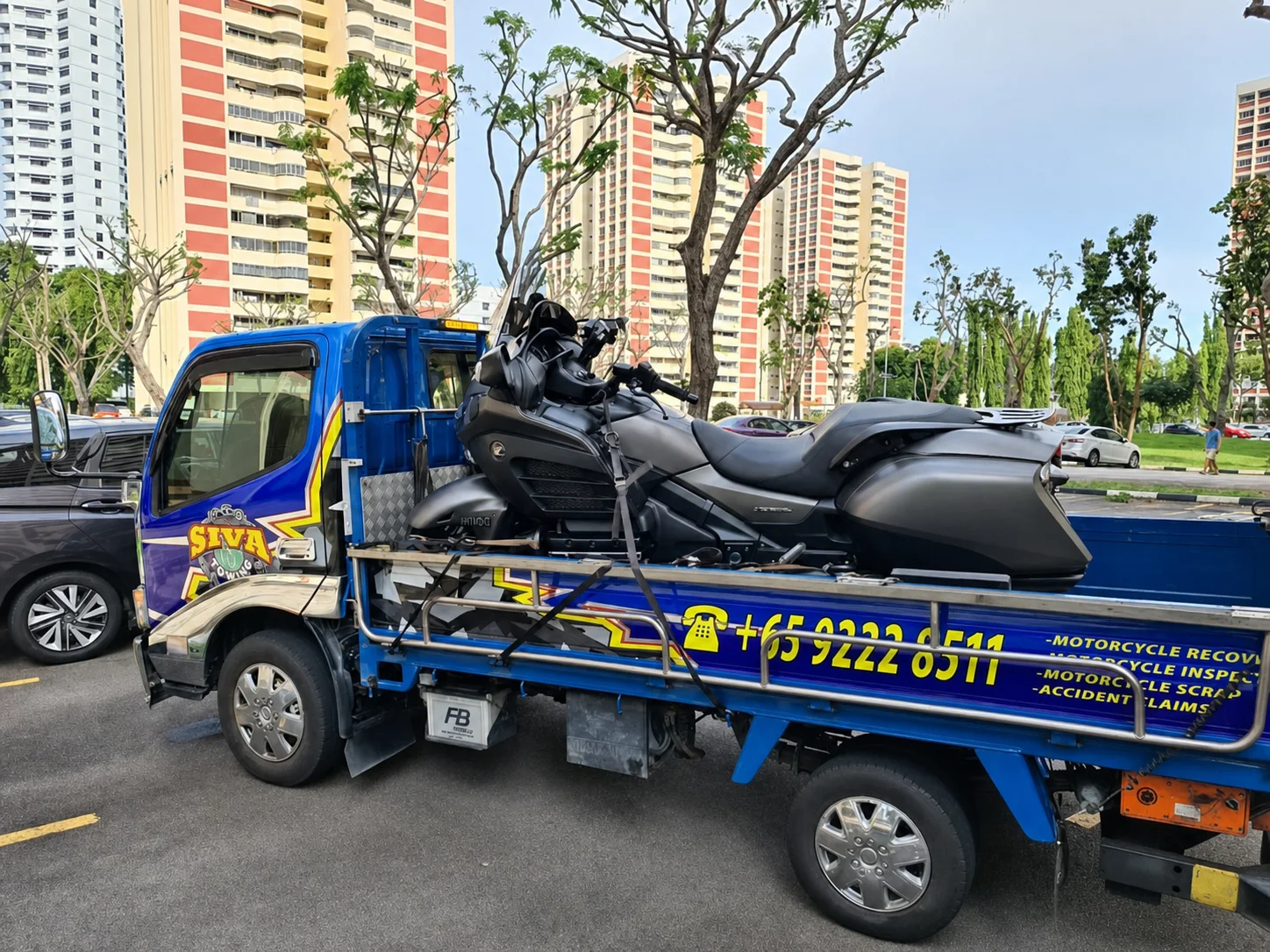 Large touring motorcycle secured on a Siva Towing recovery lorry in Singapore